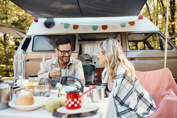 istock Happy couple talking on picnic at trailer park. 1447076942