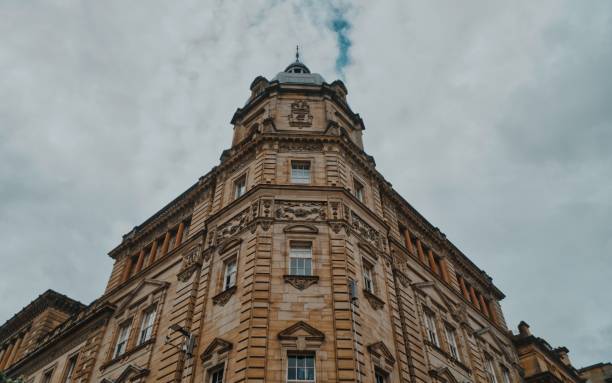 istock Low angle shot of building facade under cloudy sky in Glasgow 1447077038