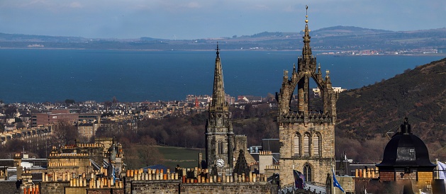 A panoramic image of High Kirk of Edinburgh in the background of Firth of Forth estuary