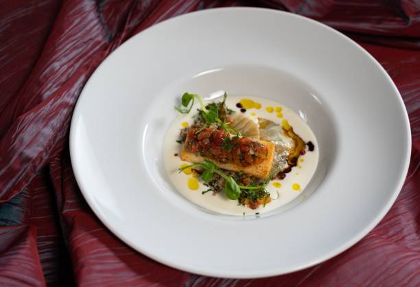 istock Plate of Cornish cod dish on a purple cloth background 1447078643