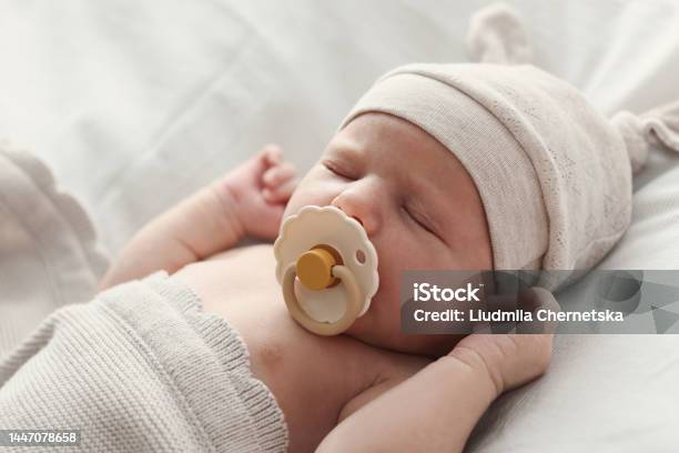 Adorable Little Baby With Pacifier Sleeping In Bed Closeup Stock Photo - Download Image Now