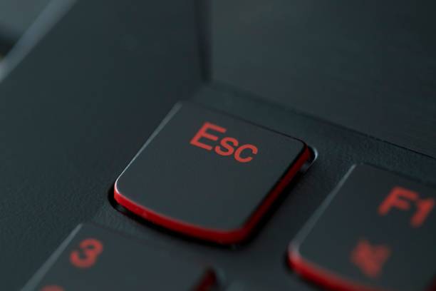 istock Closeup of a red Escape command on a black button background 1447080838