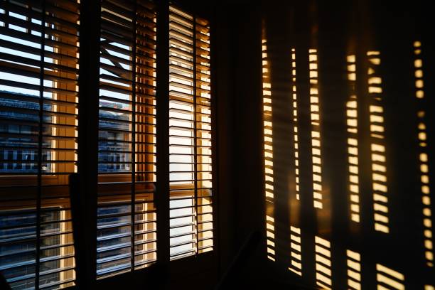 istock Wood blinds with striped reflection on the wall 1447081415