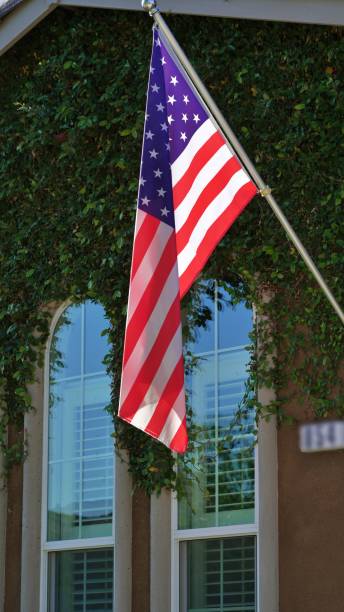 istock Vertical shot of a hanging American flag on a pole 1447083082