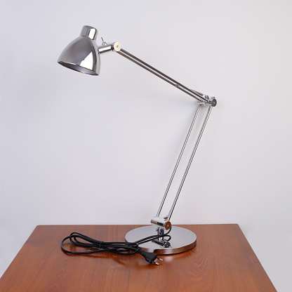 Metal table lamp on wooden table