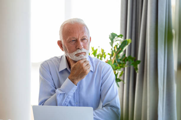 istock Financial advisor businessman using his laptop and doing some paperwork while sitting at desk and working. 1447084670