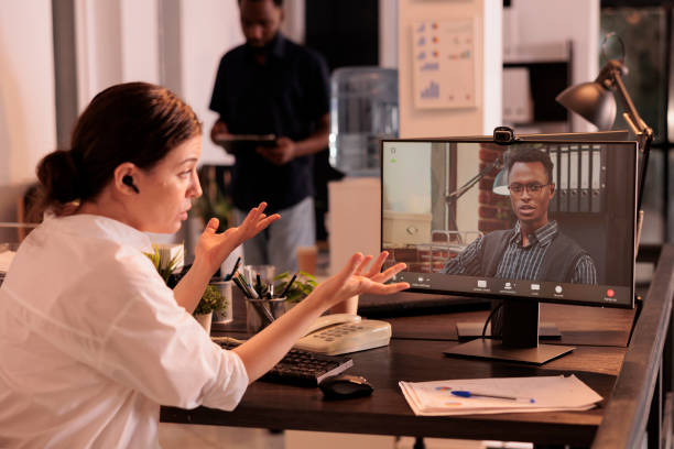 istock Employee discussing report with project manager on online meeting 1447085599