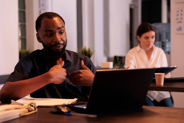 istock Employee discussing company report on videoconference with teamlead 1447086590