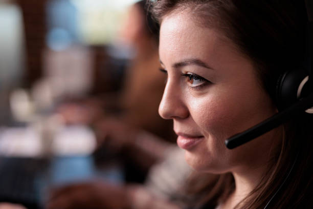 istock Telecommunication receptionist answering client call on headset 1447088579