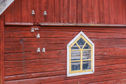 Window of an alm hut with checkered curtains
