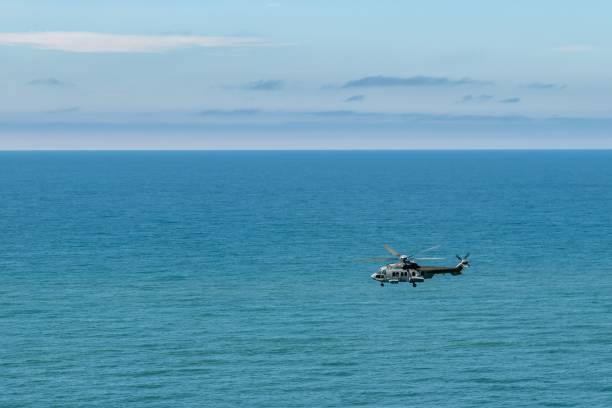 istock Helicopter flying over the sea 1447089680