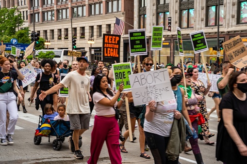– June 26, 2022: Protesters holding signs My Body My Choice, Ban bombs not Bodies, Abortion rights, People with placards supporting abortion rights at protest in USA
