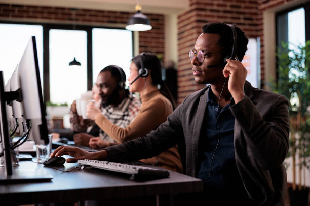 istock Male helpline assistant working at call center reception 1447091643