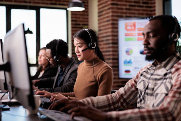 istock Asian operator working as sales assistant at call center service 1447091718