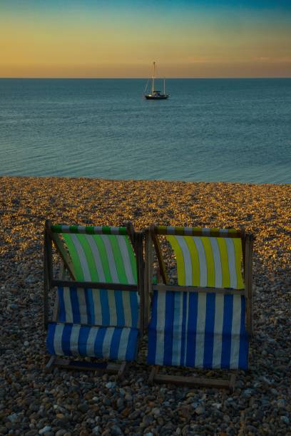 istock Vertical shot of striped deckchairs on the beach 1447091826