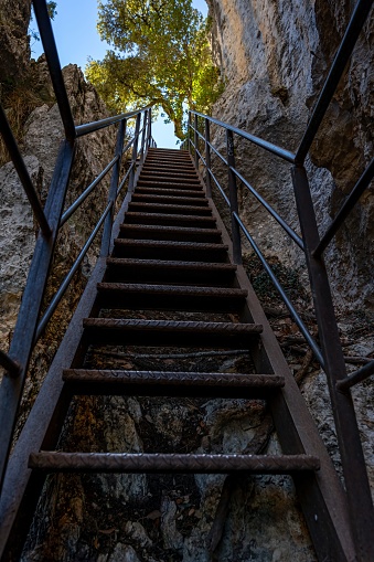 A vertical low angle of a metal stairway up on the Blanc-Martel trail in La Palud-sur-Verdon, France
