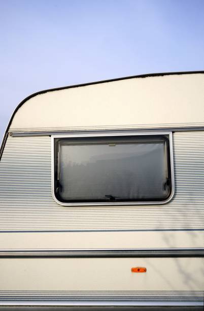 istock Vertical closeup of a small window on a light-colored van parked outdoors 1447093088