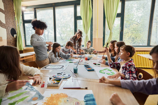 istock Schoolkids painting on art class at elementary school. 1447095296