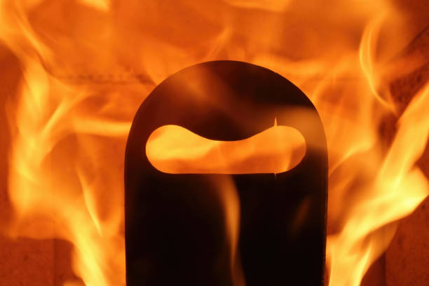 Black wooden mask burning in the fire