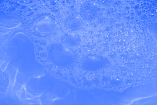 istock Defocus blurred transparent blue colored clear calm water surface texture with splashes and bubbles. Trendy abstract nature background. Water waves in sunlight with copy space. Blue watercolor shining 1447102038