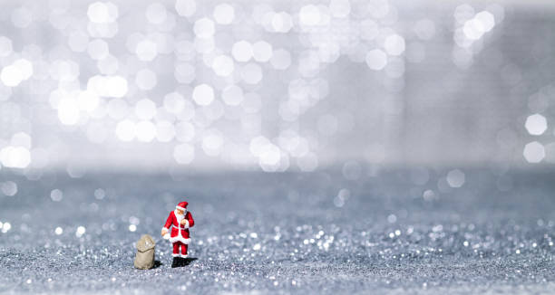 Santa Claus figurine on shiny background.