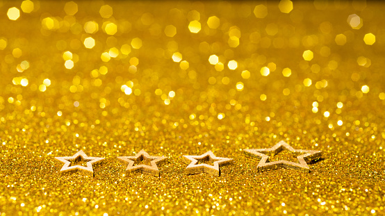 Christmas stars on shiny golden background.