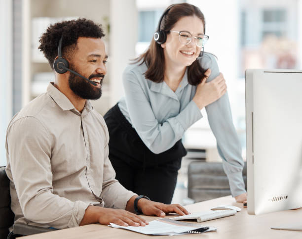 istock Diversity, call center and leader training agent or sales employee at contact support help desk customer service. Contact us, woman and telemarketing worker with a big smile after a successful deal 1447103470