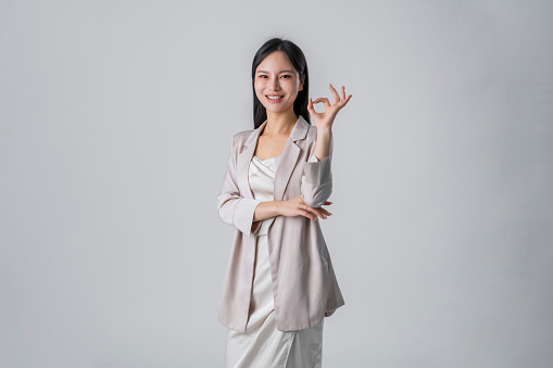 Young asian female showing okay gesture