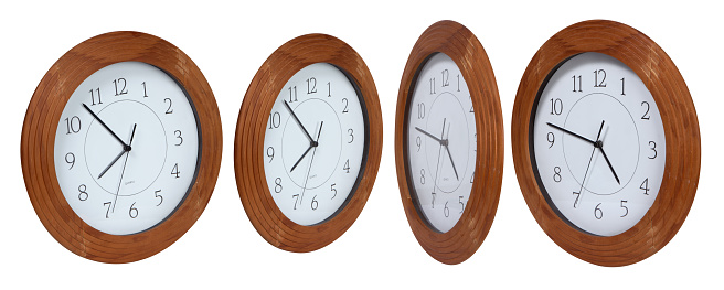 Clocks side by side forming a design on wall
