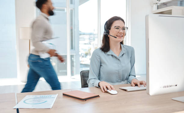 istock Woman with headset, customer support service and working at online call center or remote telemarketing business with a smile. Office crm consultant at desk, happy to help client and use PC ai for faq 1447105619