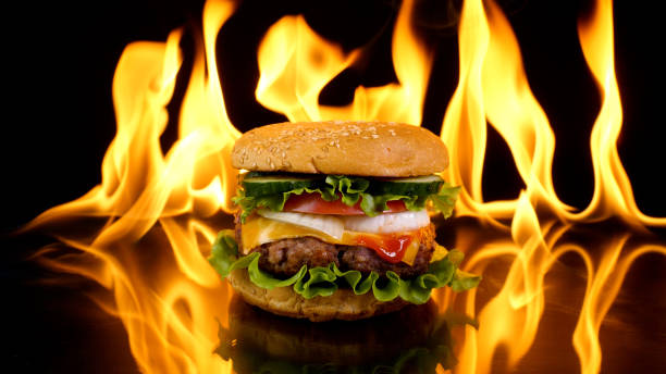istock Delicious burger on the background of fire 1447106339
