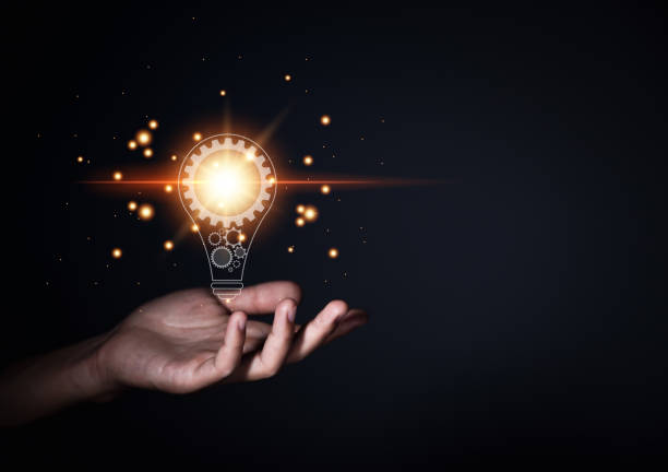 istock Creative ideas. Businessman's hand showing a light bulb with light 1447107667