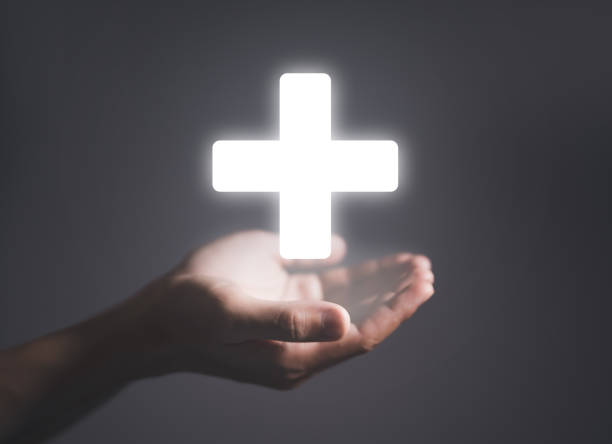 istock medical plus sign on dark background 1447107698