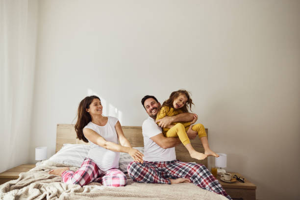 istock Cheerful family having fun during morning on a bed. 1447108872