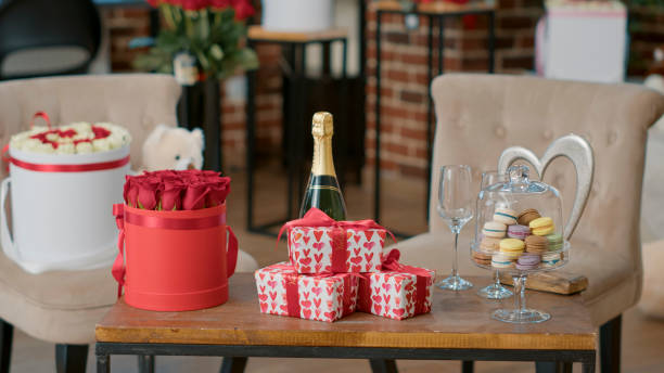 istock Romantic valentine day luxury setup with gift boxes champagne and macarons on coffee table 1447109874