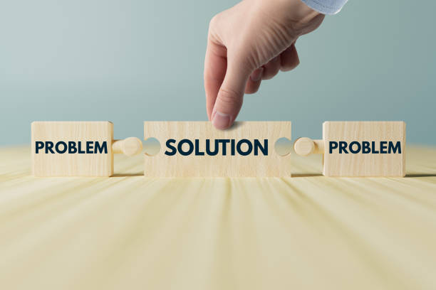 istock The hand holds wooden blocks, a puzzle with the inscription problem and solution. 1447110006