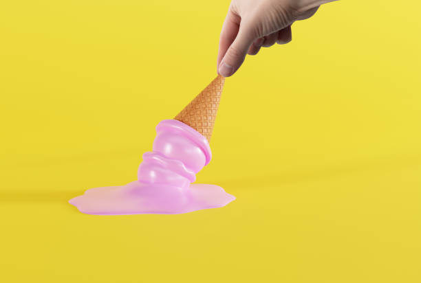 istock Hand holds melted ice in a waffle on the ground and yellow background. 1447110054
