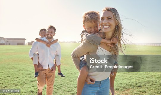 istock Family, kids and piggy back at park, nature or outdoors on vacation, holiday or summer trip. Love, support and caring parents, man and woman bonding with boys, carrying and enjoying fun time together 1447113034