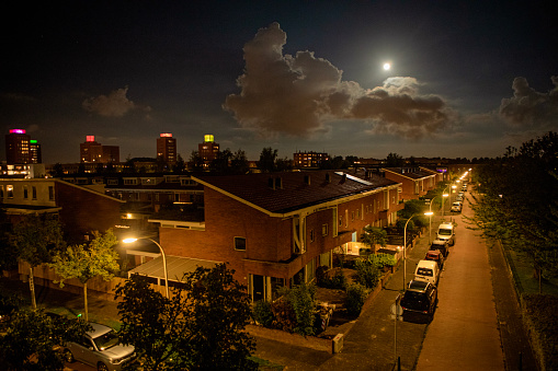 Dutch city street and lights in the evening moonlight in Den Haag