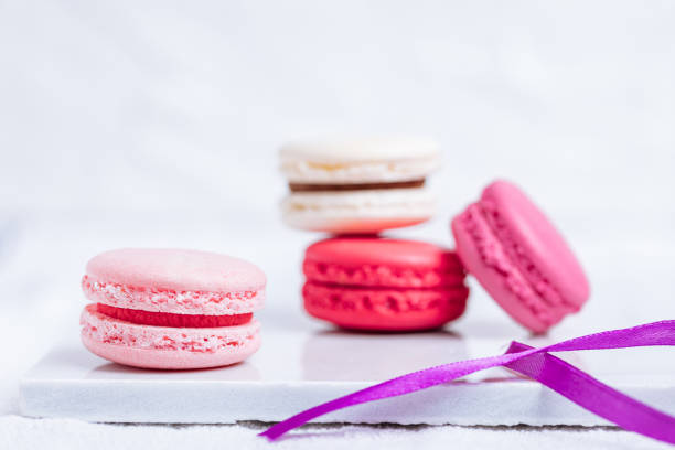 Colorful Pink and Red Macarons in Bright Minimal Scene. Macaroon