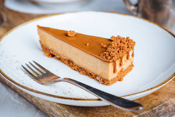 istock Cheesecake with Caramel Topping Sauce and Cookie Crumbles 1447115153