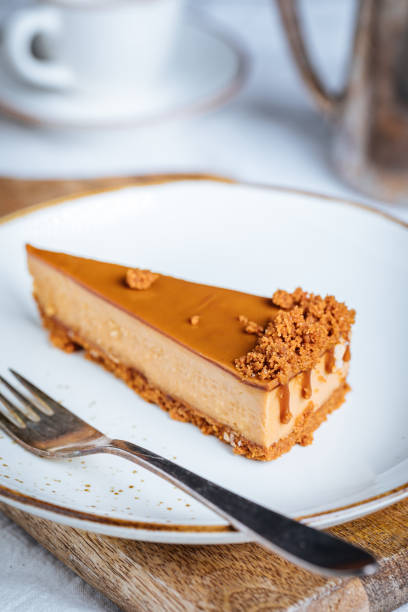 istock Cheesecake with Caramel Topping Sauce and Cookie Crumbles 1447115169