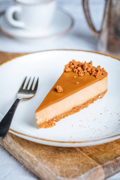 istock Cheesecake with Caramel Topping Sauce and Cookie Crumbles 1447115173