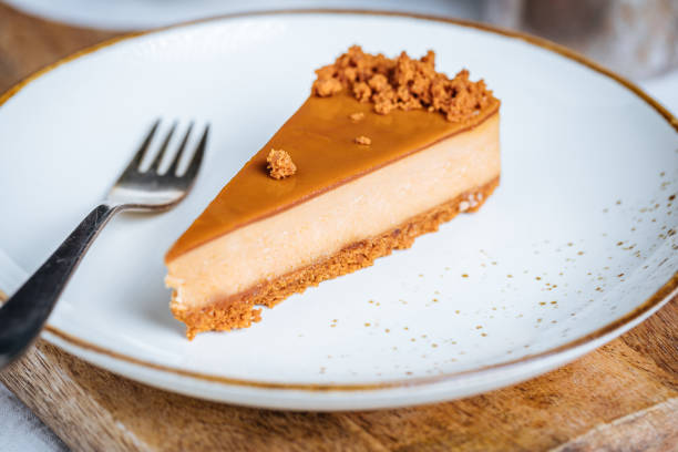 istock Cheesecake with Caramel Topping Sauce and Cookie Crumbles 1447115184