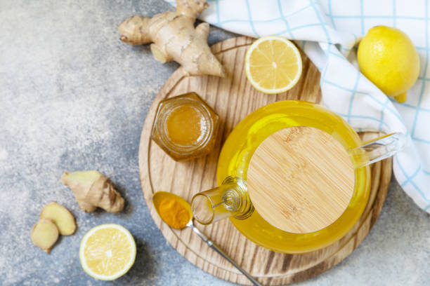 Healthy organic vegan drink. Antioxidant ginger turmeric lemon tea with honey on a stone table. Winter tea, Immunity boosting drink. View from above. Healthy organic vegan drink. Antioxidant ginger turmeric lemon tea with honey on a stone table. Winter tea, Immunity boosting drink. View from above. 30132 stock pictures, royalty-free photos & images