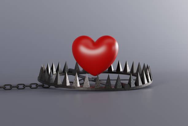 istock Heart over a snare, a trap on a dark background. 1447116246