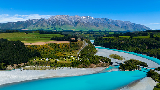Aerial view with road of highway as bridge at Rakaia River lagoon Valley as green field againts with blue sky background
