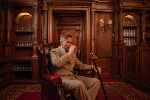 A handsome elegant 1920s style gentleman in a luxury brown bar