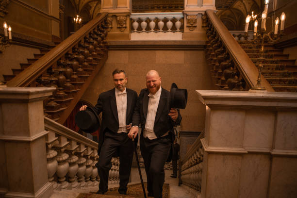 istock Two handsome 1920s style gentlemen on a luxury stately home staircase 1447121043