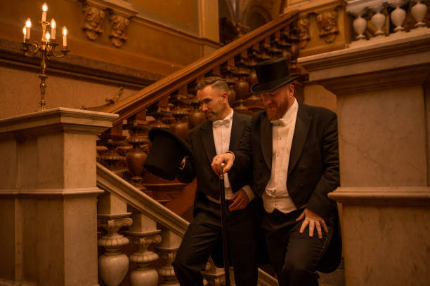 istock Two handsome 1920s style gentlemen on a luxury stately home staircase 1447121060